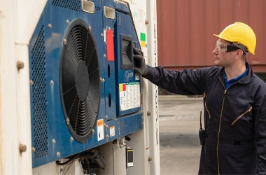 A technician performs maintenance on a cold storage facility. Merit Mechanical performs cold storage maintenance.