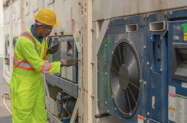 A technician examines cold storage equipment. Merit Mechanical offers cold storage repair in Galesburg IL.