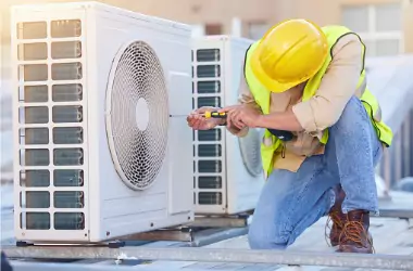 A tech is seen servicing an HVAC unit. What are SEER ratings for commercial HVAC systems? Merit Mechanical can explain SEER ratings in Peoria and Bloomington IL.