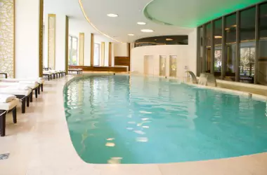 An indoor pool is seen. Merit Mechanical provides Pool Dehumidification.