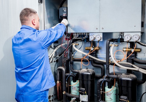 A tech is seen working on a mechanical system. Merit Mechanical is the top Mechanical Contractors in Peoria IL.