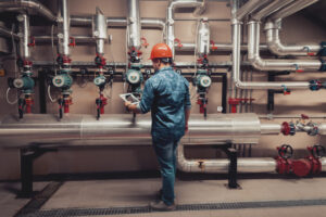 A member of Merit Mechanical Service tackles boiler service at a business