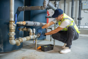 A technician from Merit Mechanical Service performs boiler service for a business